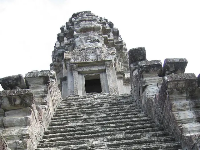 In this image I can see an ancient architecture, walls, steps and sky.