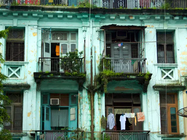 In this image I can see few trees which are green in color and a building which is also green in...