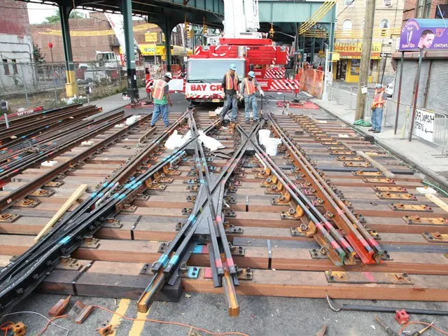 In the picture we can see some railway tracks and some people are constructing it and they are...